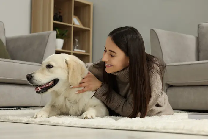 Happy woman with cute Labrador Retriever